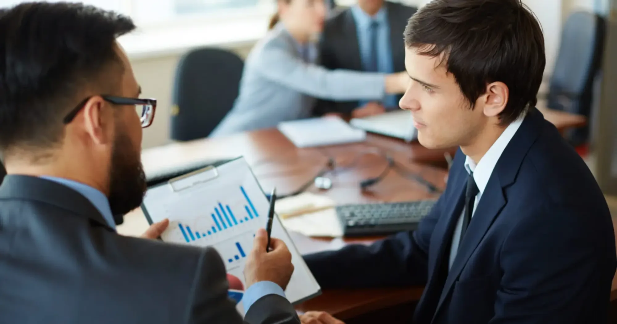 specialist-holding-document-with-bar-graphs-1536x1024 (1)